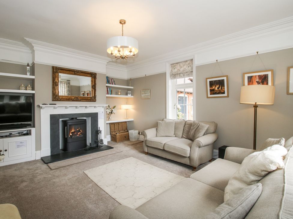 A living room with a sofa and fireplace at The Old Vicarage in Kimbolton near Leominster