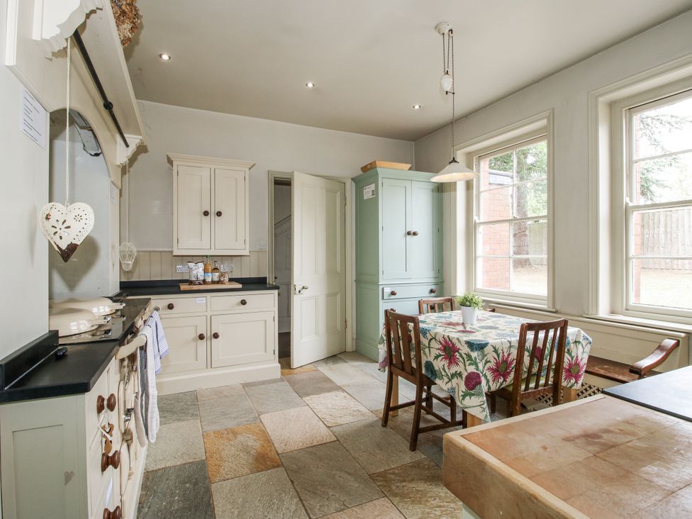 A kitchen with a table and chairs at The Old Vicarage in Kimbolton near Leominster