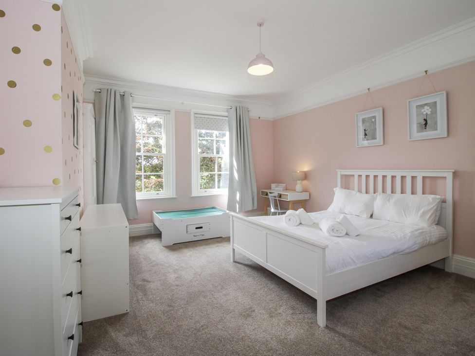 A bedroom with a bed and nightstand at The Old Vicarage in Kimbolton near Leominster