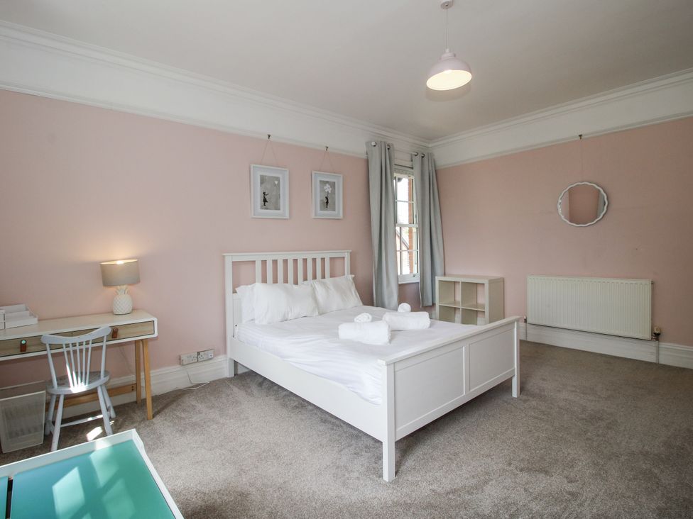 A bedroom with a bed and desk at The Old Vicarage in Kimbolton near Leominster