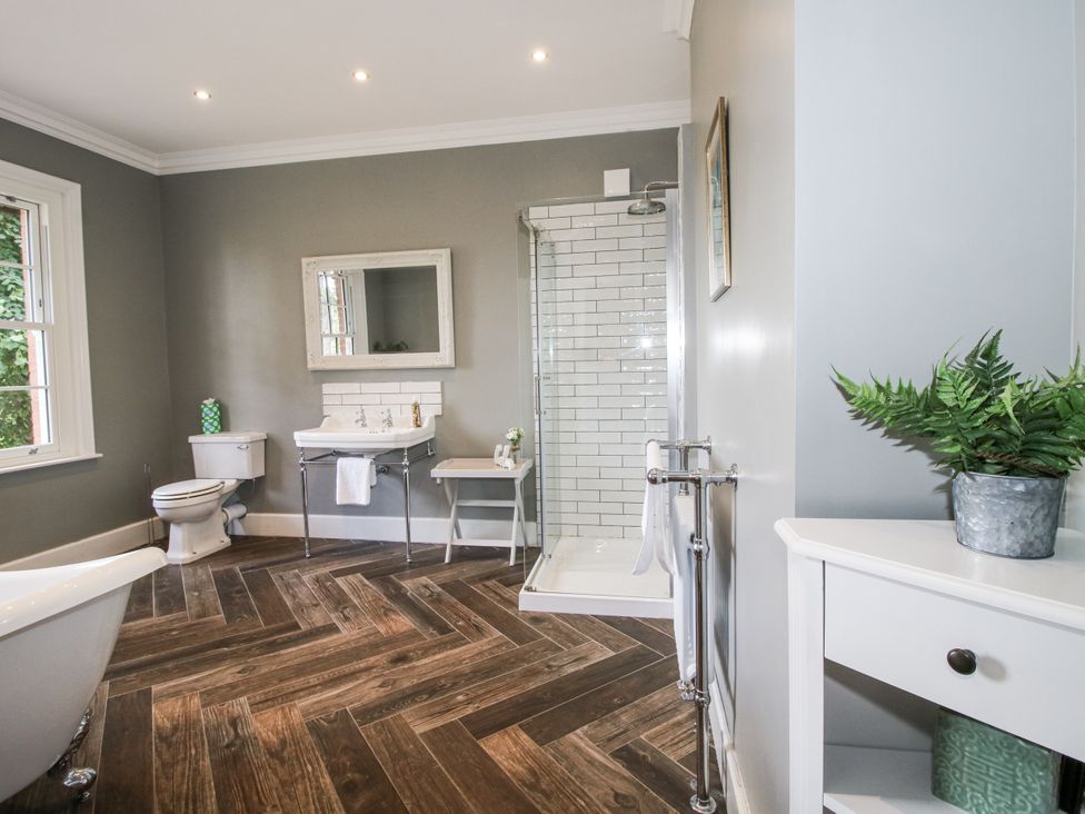 A bathroom with a bathtub and shower at The Old Vicarage in Kimbolton near Leominster