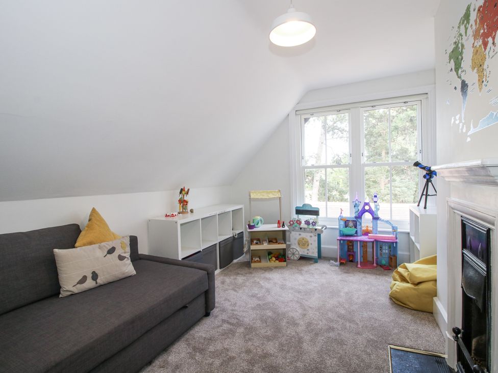 A playroom with a sofa and toy storage at The Old Vicarage in Kimbolton near Leominster