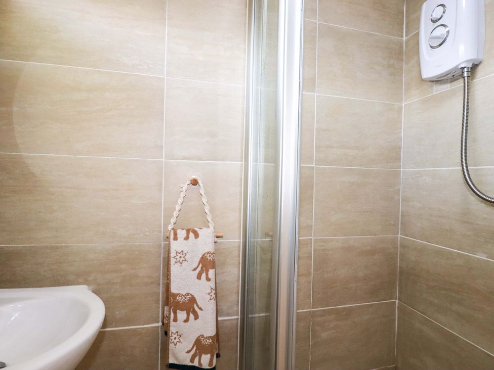 A bathroom with a towel hanging and a shower at Cozy Retreat in Tregolds