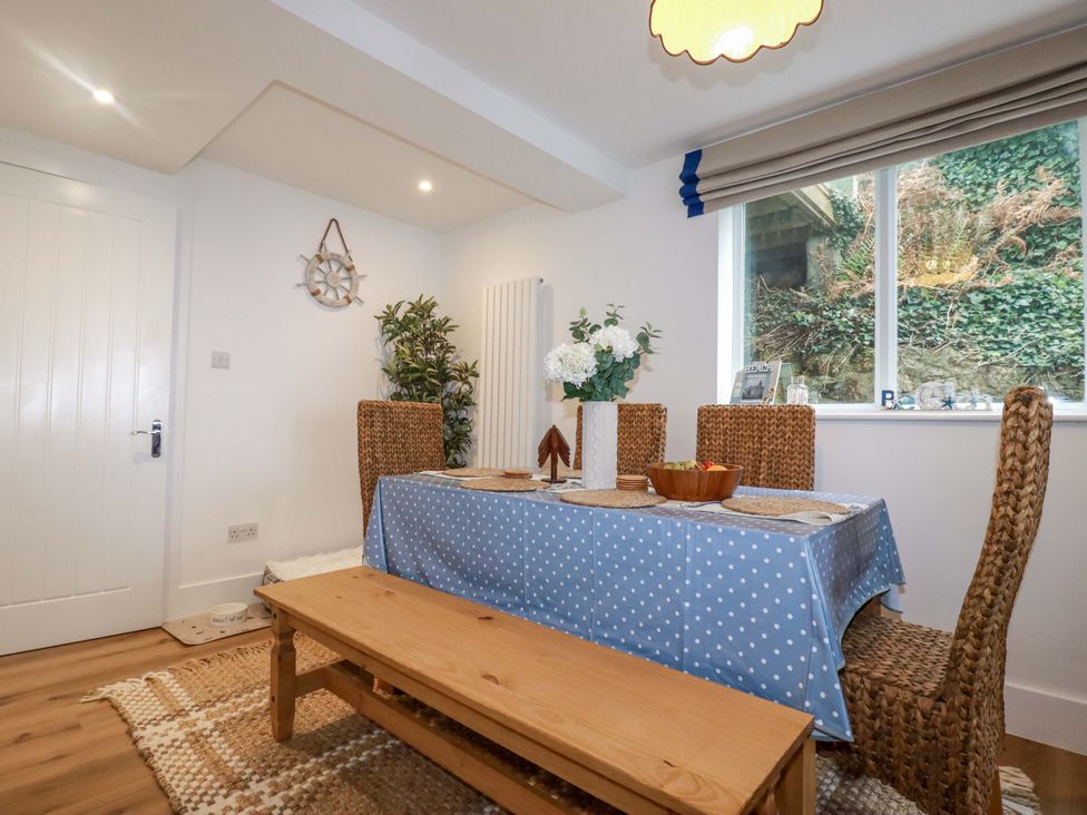 A dining room with a table and chairs at Ocean Edge in Sennen Cove