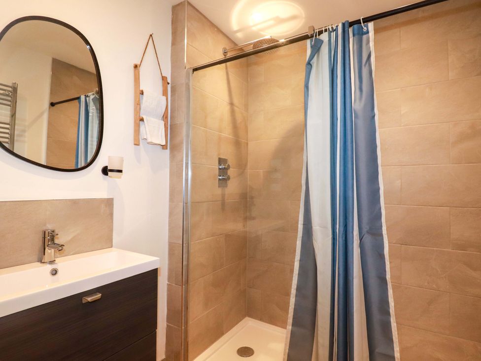 A bathroom with a shower and a sink at Ocean Edge Sennen Cove