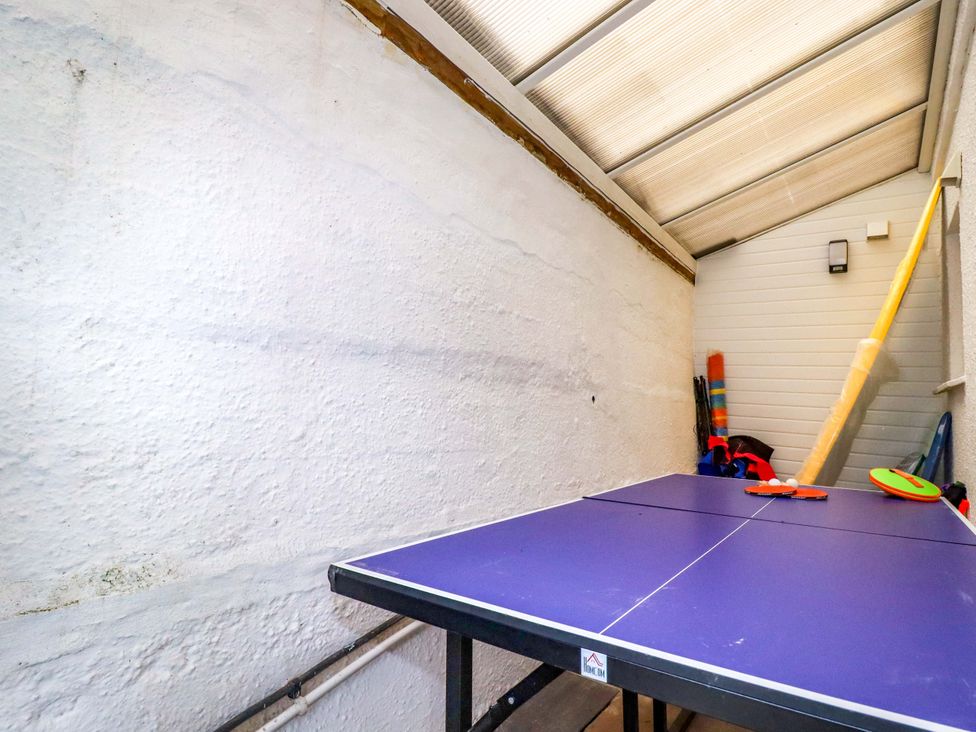 A ping pong table in a room with sports equipment at Ocean Edge in Sennen Cove