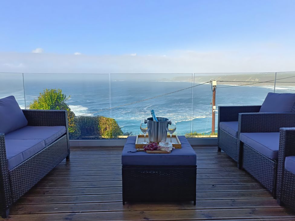 Outdoor seating area with ocean view at Ocean Edge in Sennen Cove