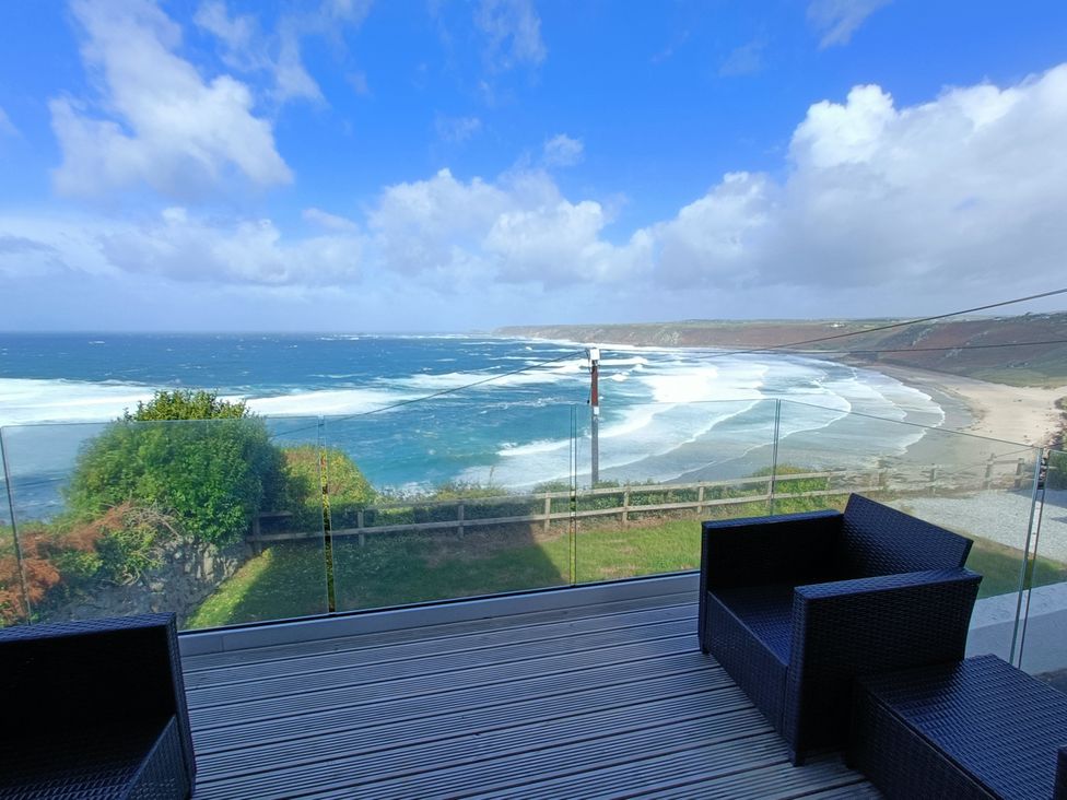 A view of the sea and beach from a deck at Ocean Edge in Sennen Cove