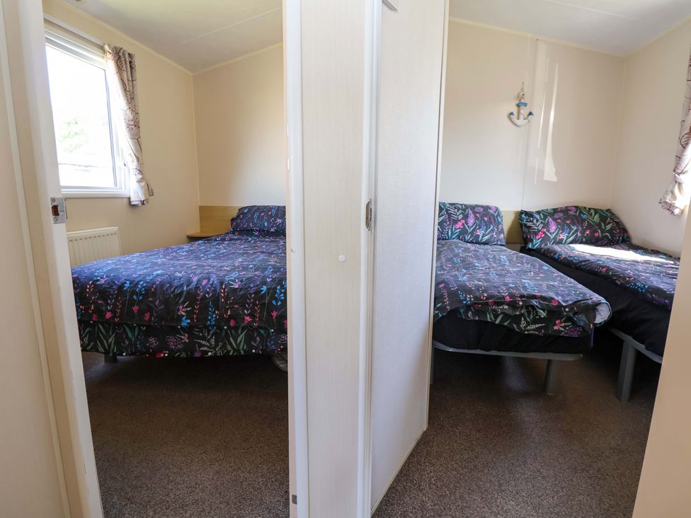 A bedroom with a double bed and a single bed at Willerby Aurora B14 in Towyn
