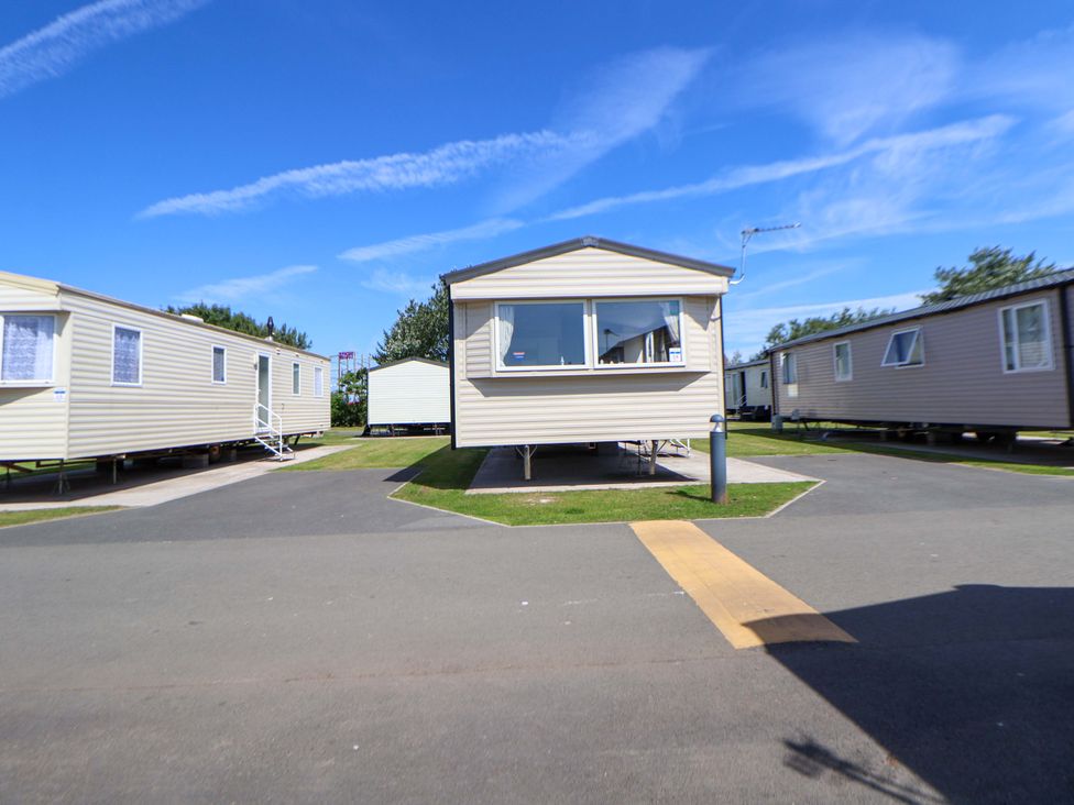 A row of static caravans with a pathway in Towyn