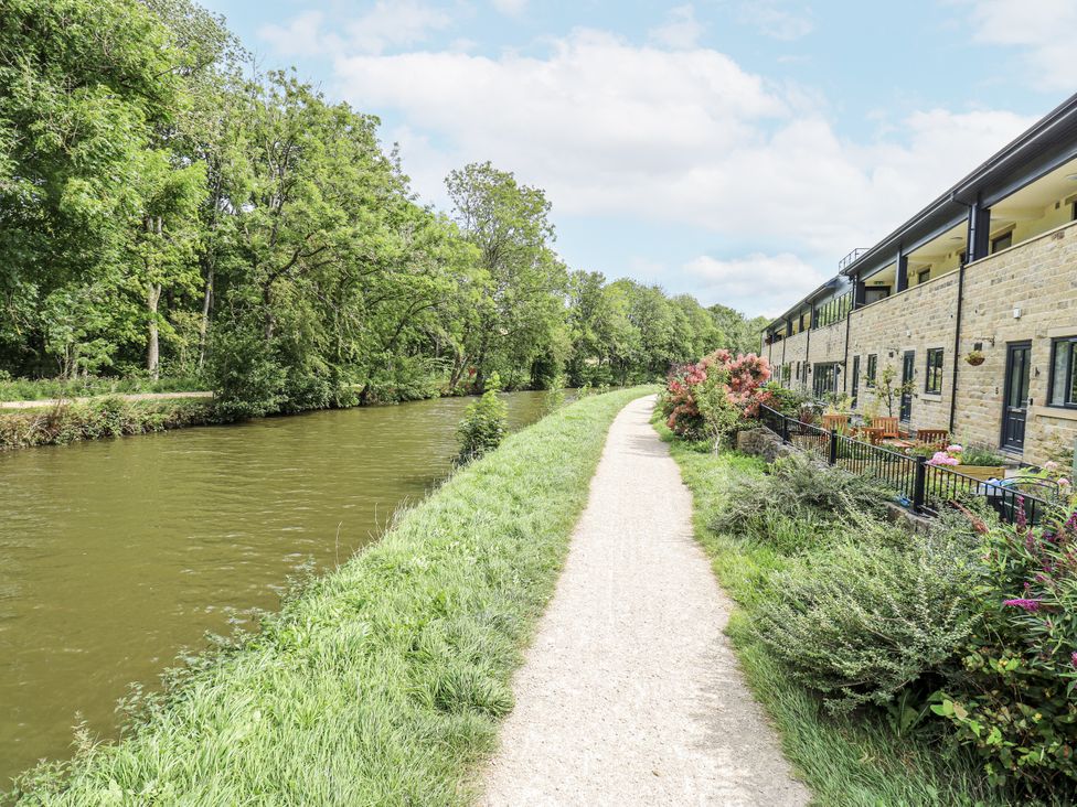 A canal with a path and building alongside at Apartment 5 in Skipton