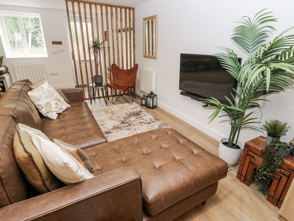 A living room with a sofa and television at Apartment 5 Skipton