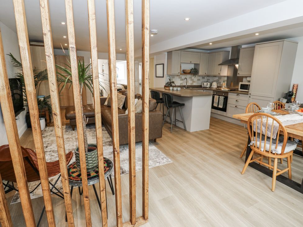A living room and kitchen area with furniture at Apartment 5 Skipton