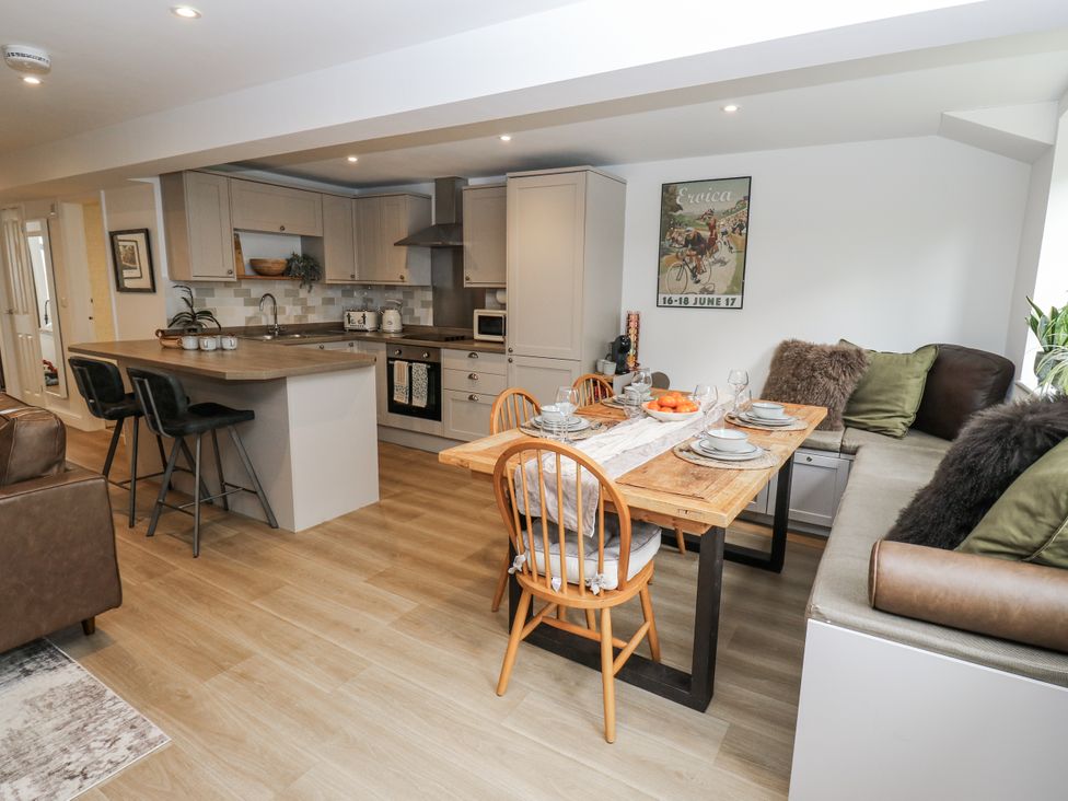 A kitchen with dining area and bar stools at Apartment 5 in Skipton