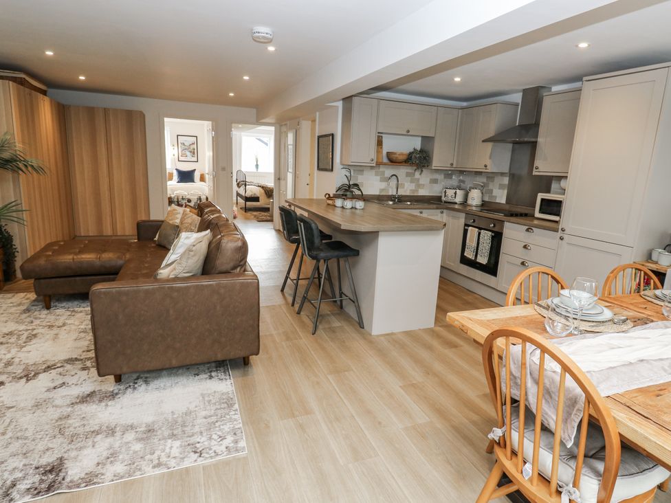 A living room featuring a sofa and kitchen area at Apartment 5 Skipton