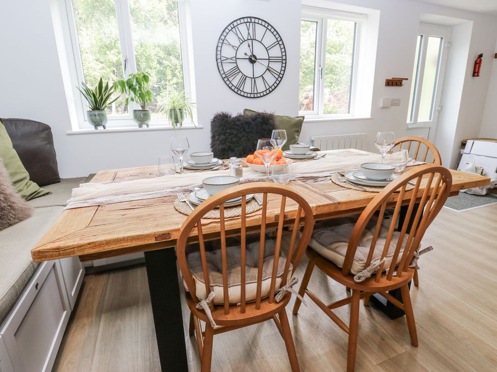 A dining room with wooden table and chairs at Apartment 5 in Skipton