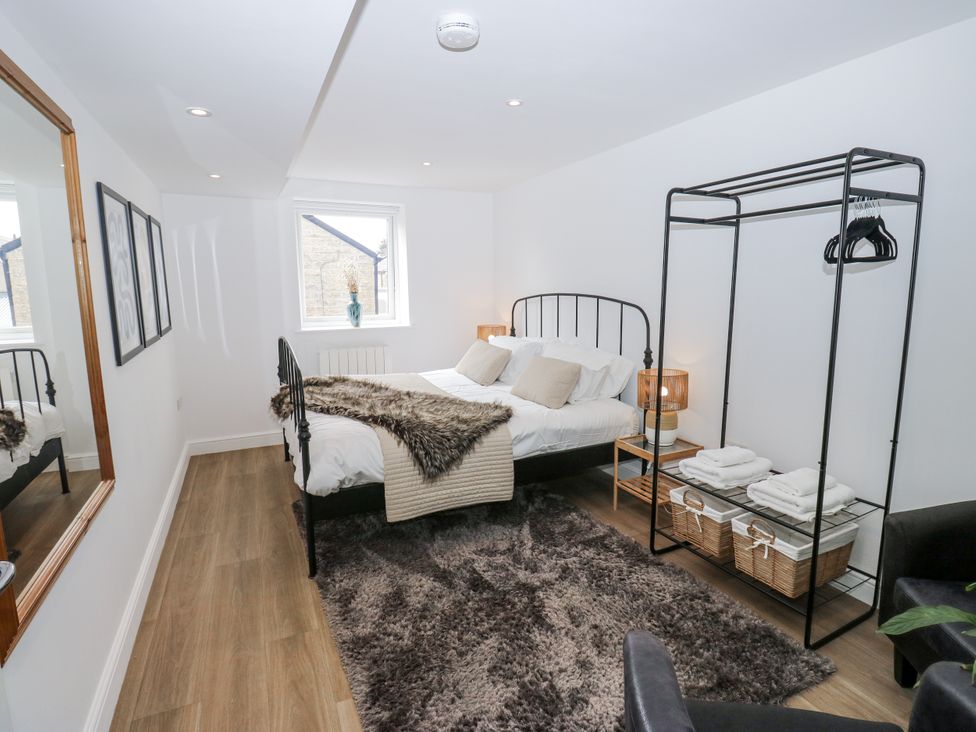 A bedroom with a bed and wardrobe at Apartment 5 in Skipton
