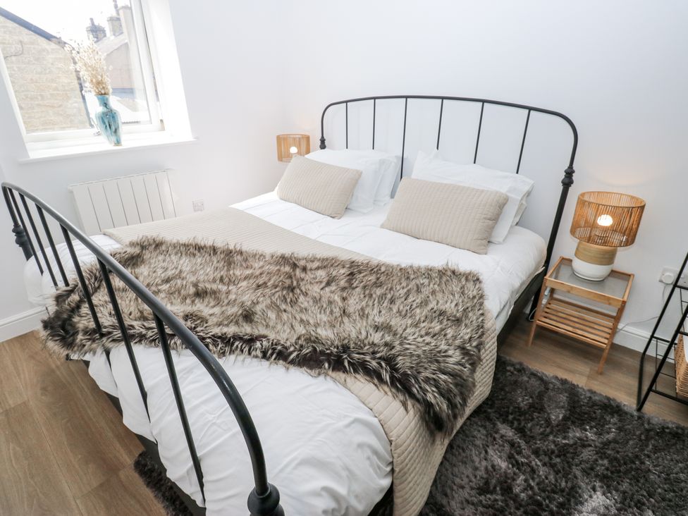 A bedroom with a bed and bedside table at Apartment 5 Skipton