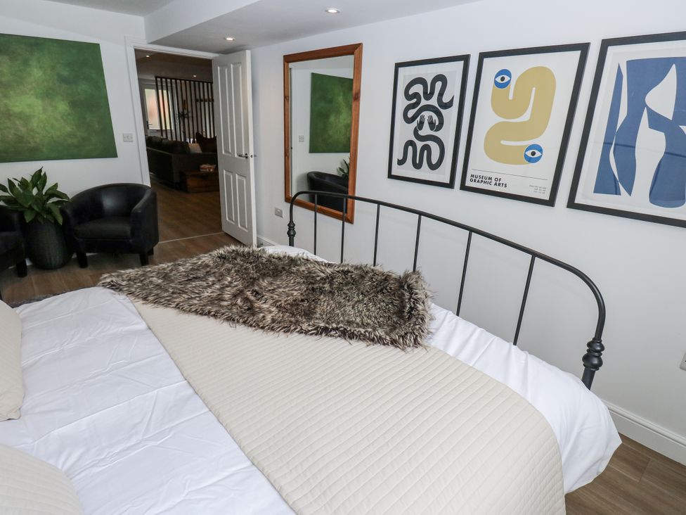 A bedroom with a bed and artwork on the wall at Apartment 5 in Skipton