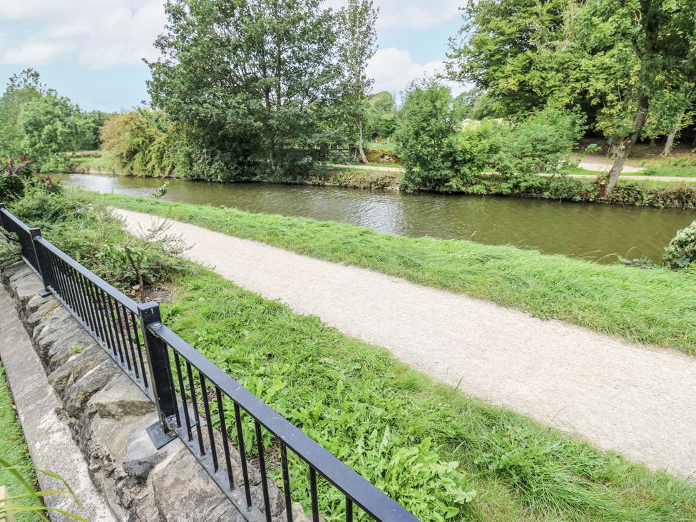 A view of a canal with a path and trees at Apartment 5 in Skipton
