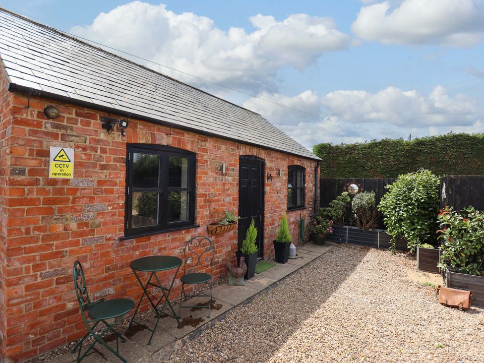 An outdoor area with benches and plants at The Paw Barn in Scrane End near Boston