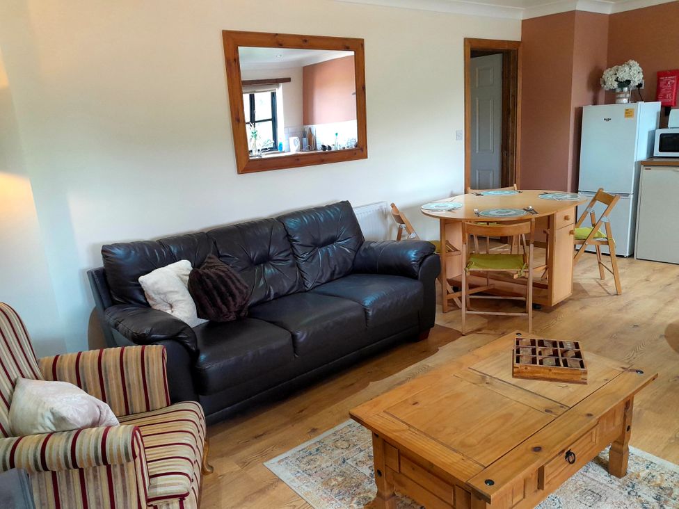 A living room with a sofa, dining table and chairs at The Paw Barn in Scrane End near Boston