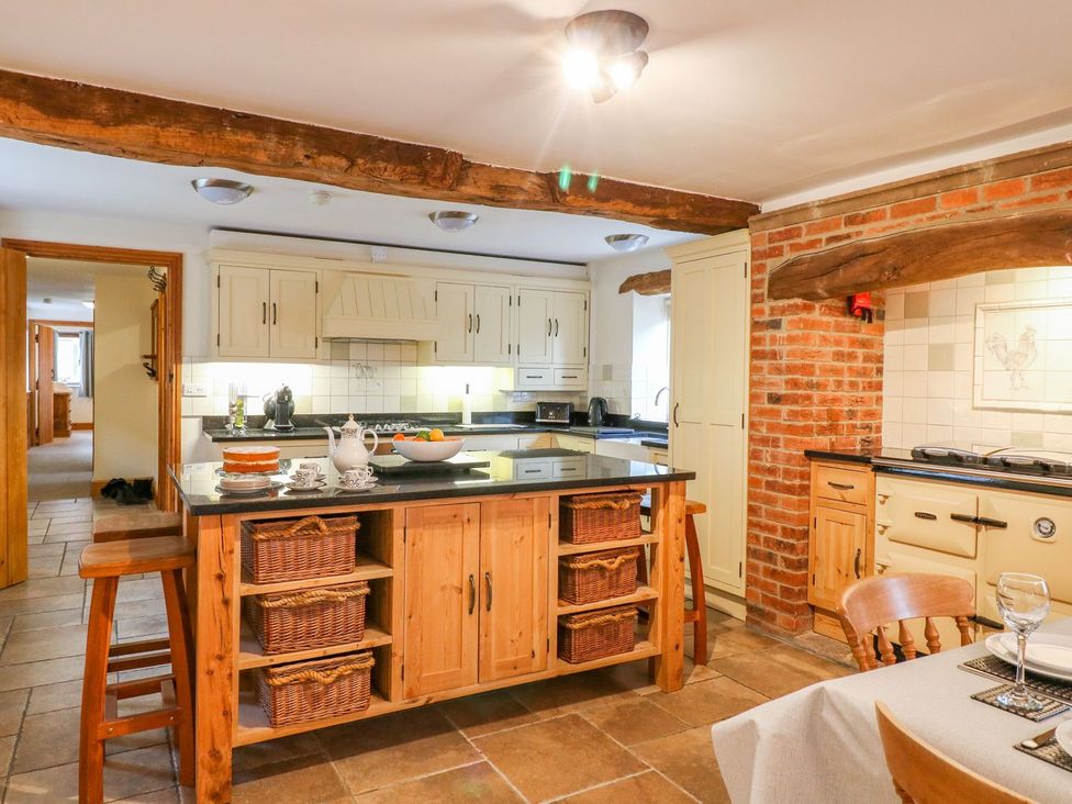 A kitchen with an island and baskets at The Barn in Wirksworth