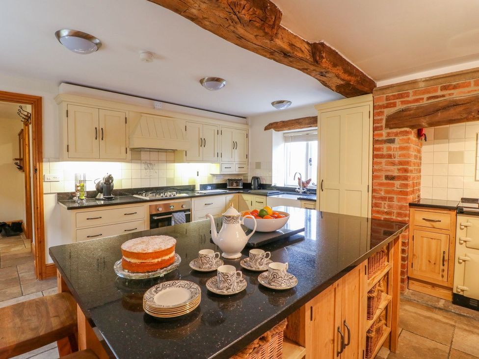A kitchen with a stove and sink at The Barn in Wirksworth