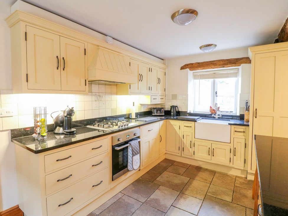 A kitchen with cabinets and appliances at The Barn in Wirksworth