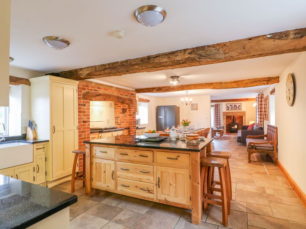A kitchen with an island and dining area at The Barn in Wirksworth
