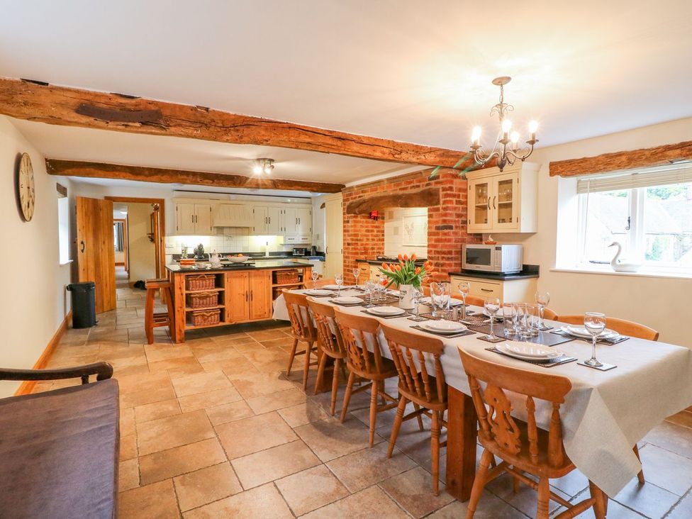 A kitchen with a dining table set for a meal at The Barn in Wirksworth