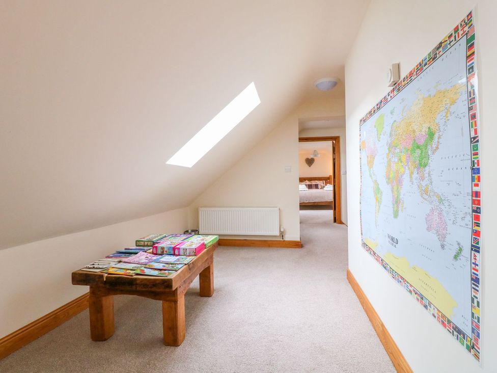 A hallway with a table and a world map at The Barn in Wirksworth
