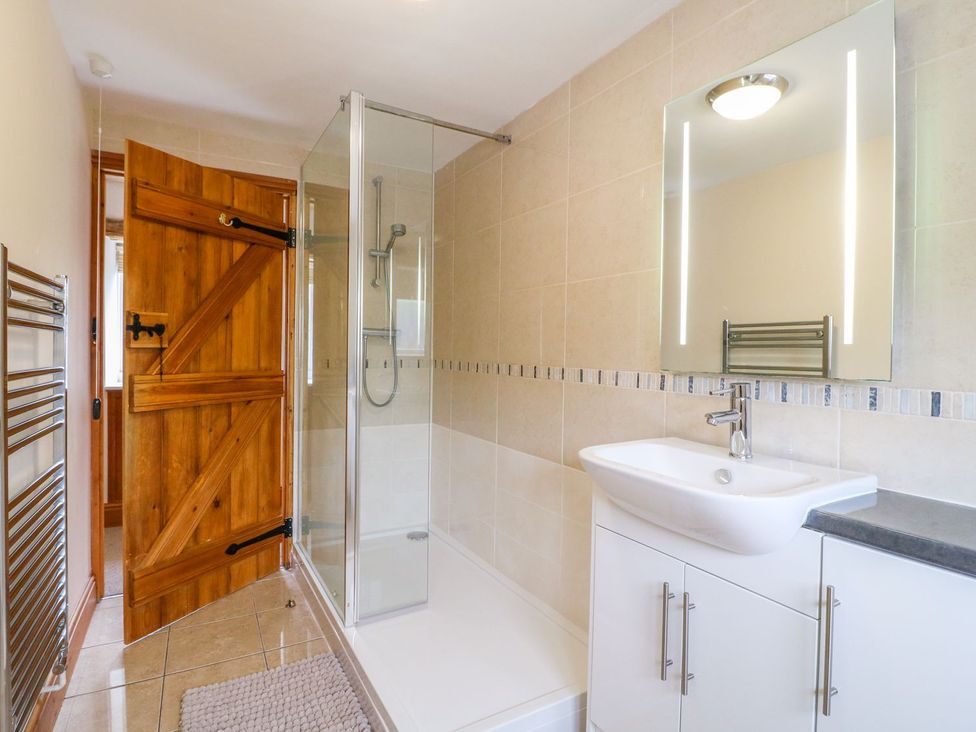 A bathroom with a shower and sink at The Barn in Wirksworth
