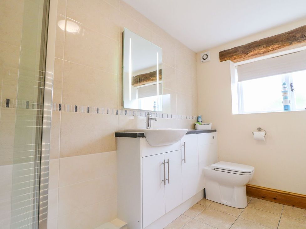 A bathroom with a sink and shower at The Barn in Wirksworth