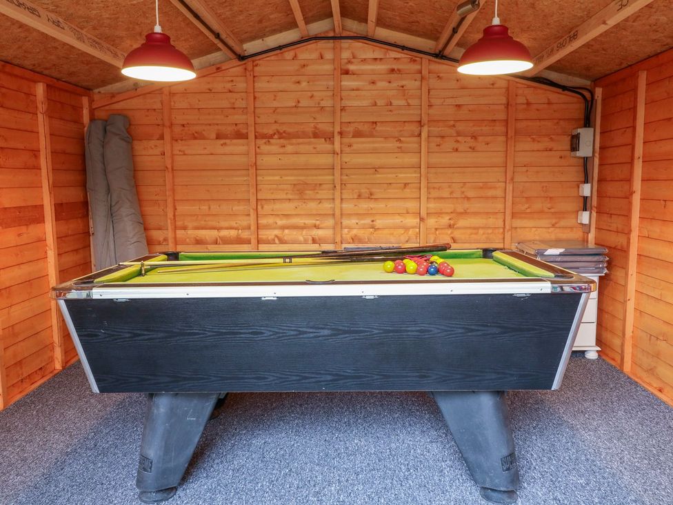 A game room with a pool table at The Barn in Wirksworth