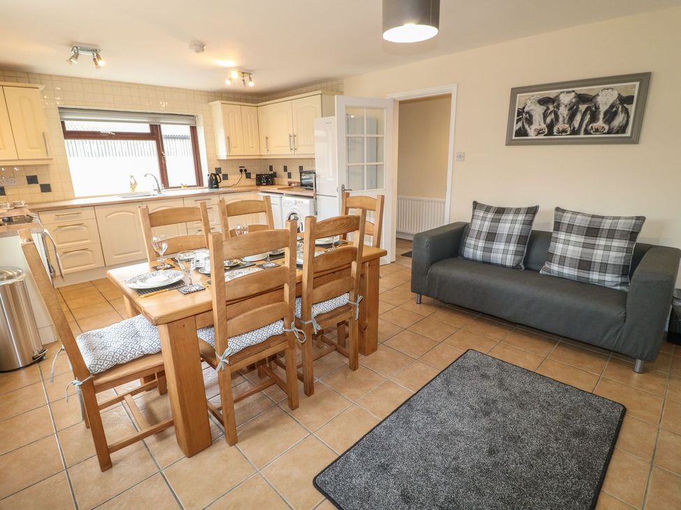 A kitchen with dining table and chairs at The Lodge in Wirksworth