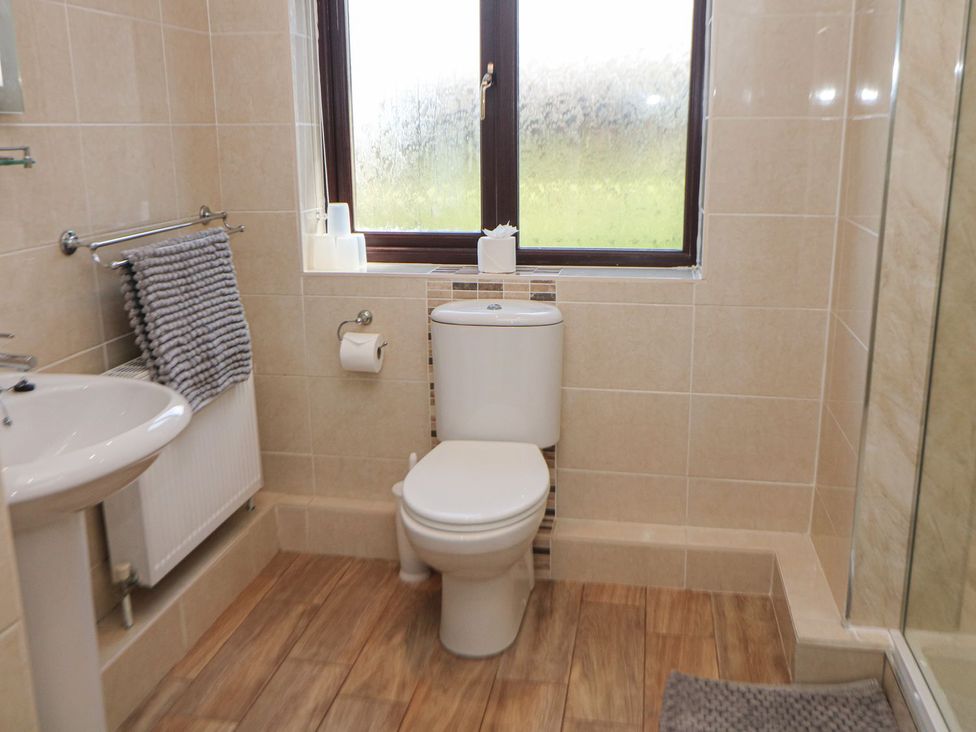 A bathroom with a sink and toilet at The Lodge in Wirksworth