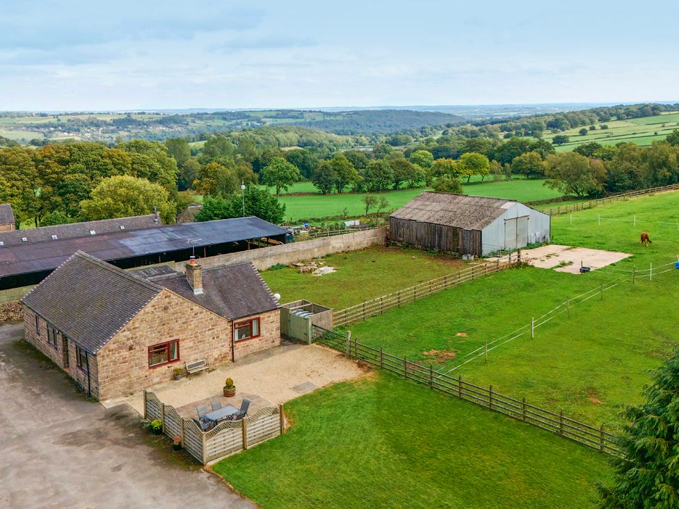 A farm with a house and barn in a rural area at The Lodge in Wirksworth