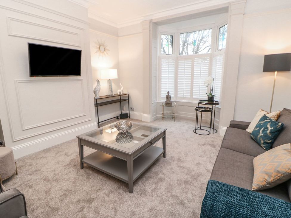 A living room with a sofa, coffee table and television at 16 Seafield Terrace South Shields