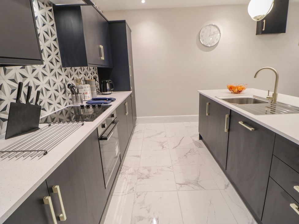 A kitchen with cabinets and a sink at 16 Seafield Terrace in South Shields