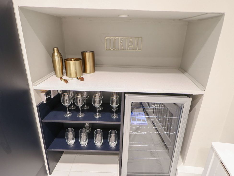A bar area with wine glasses and a cooler at 16 Seafield Terrace South Shields