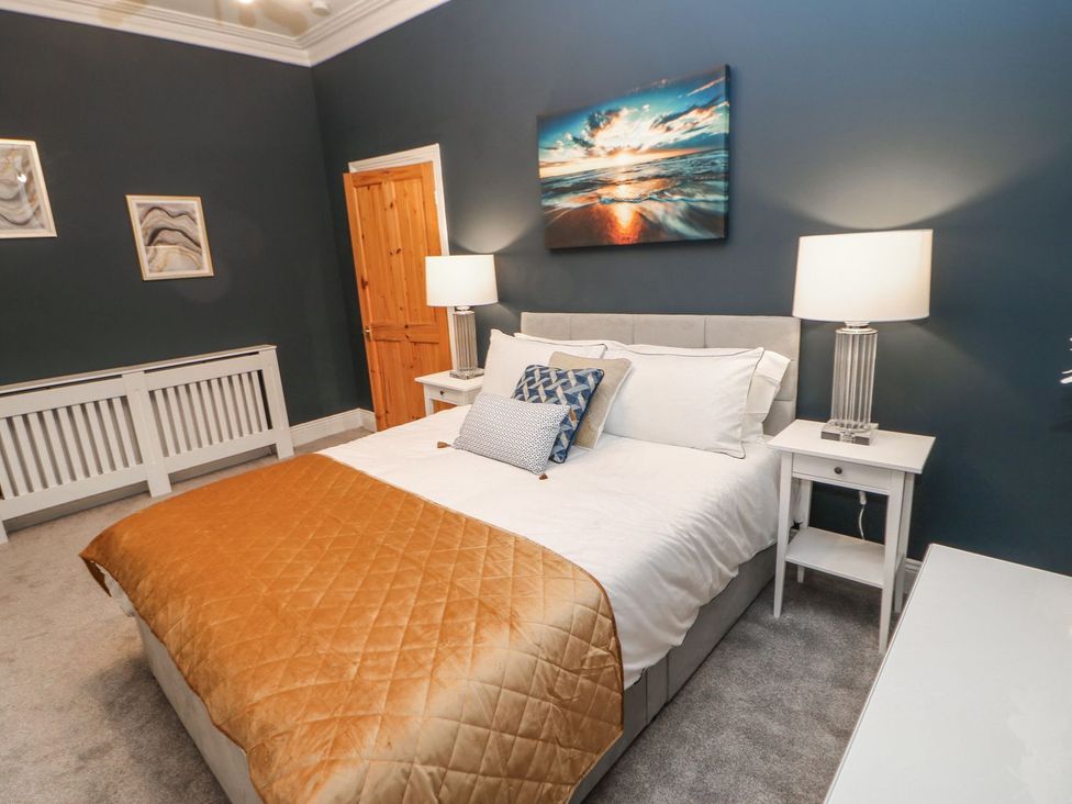 A bedroom with a bed and bedside tables at 16 Seafield Terrace South Shields