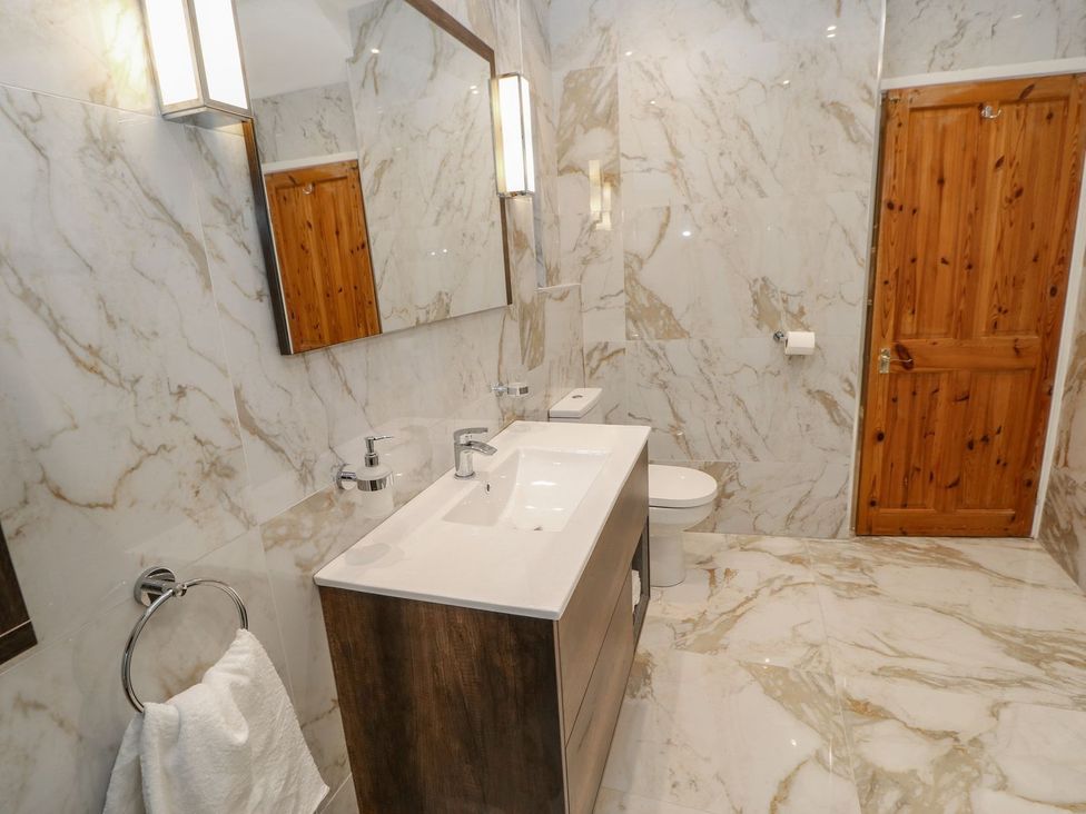 A bathroom with a sink, toilet, and mirror at 16 Seafield Terrace South Shields