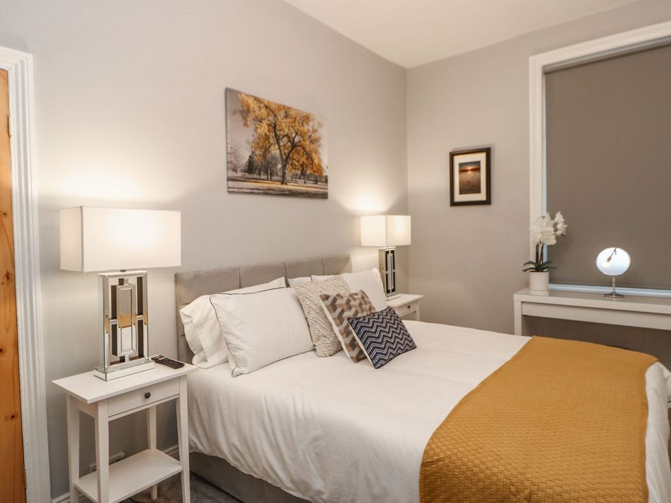 A bedroom with a bed and lamps at 16 Seafield Terrace South Shields