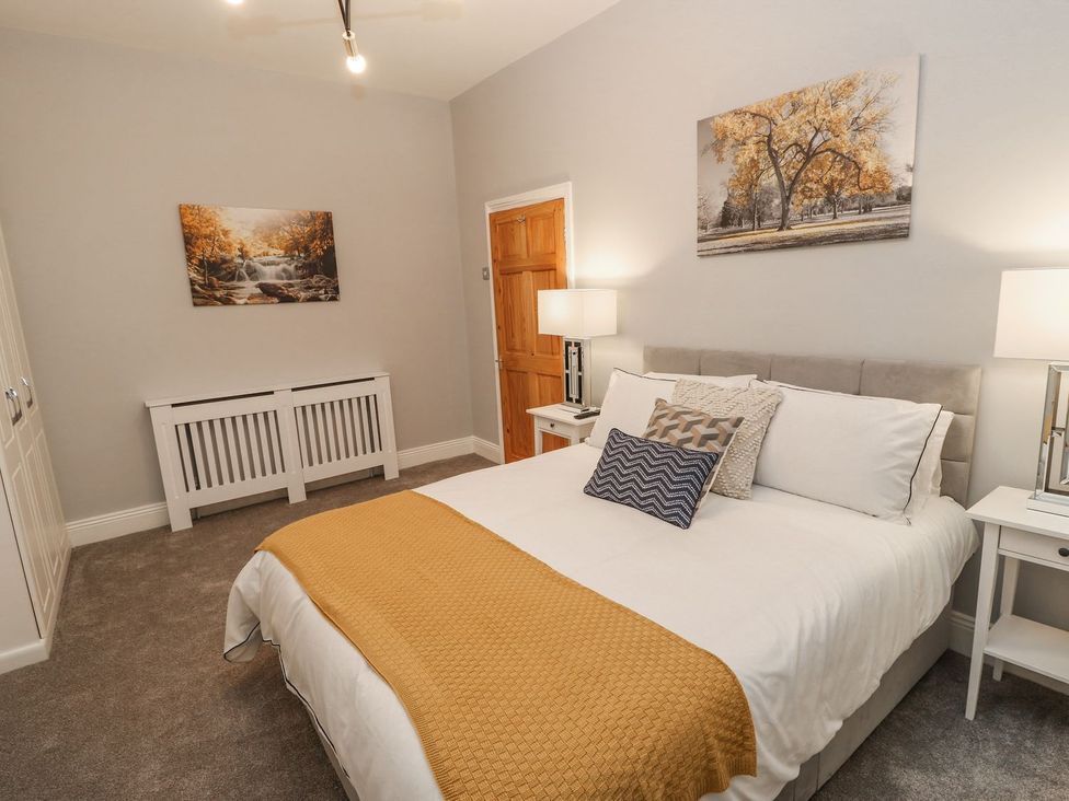 A bedroom with a bed and nightstands at 16 Seafield Terrace, South Shields