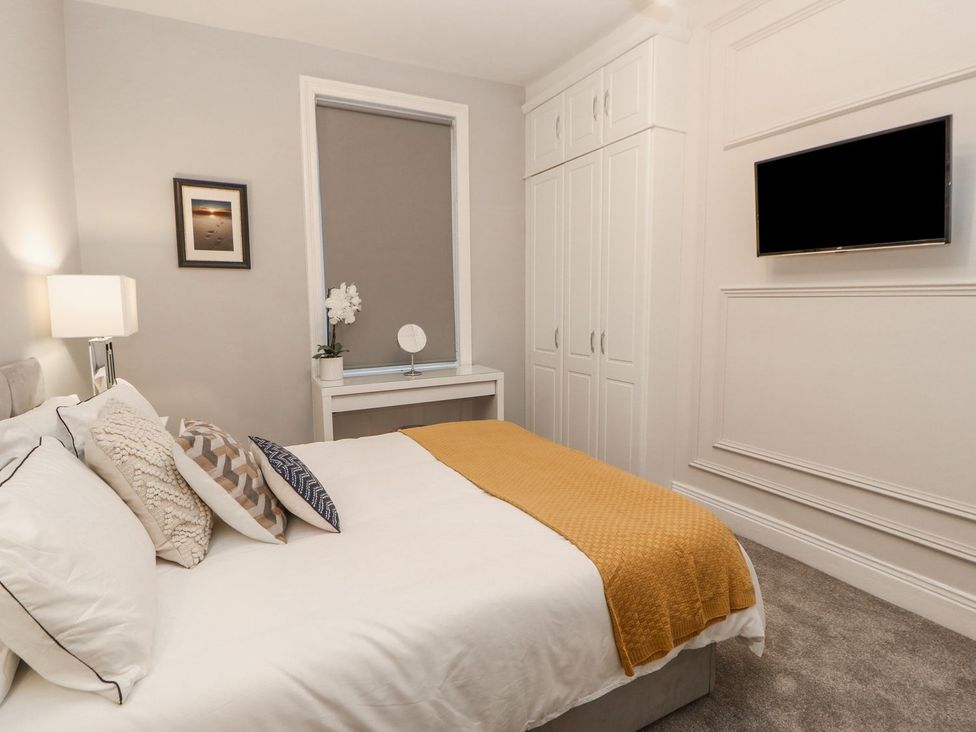 A bedroom with a bed and wardrobe at 16 Seafield Terrace in South Shields