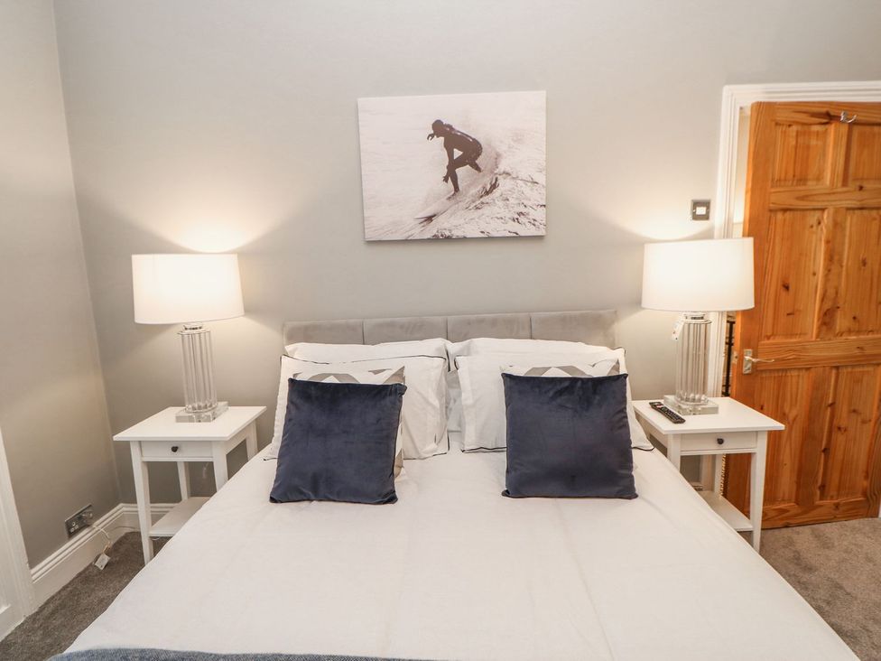 A bedroom with a bed and nightstands at 16 Seafield Terrace South Shields