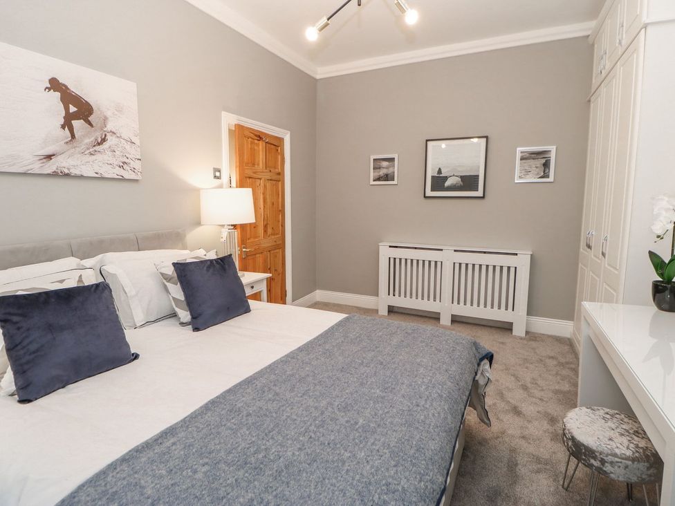 A bedroom with a bed and lamp at 16 Seafield Terrace in South Shields