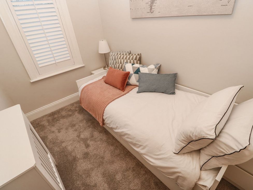A bedroom with a bed and decorative pillows at 16 Seafield Terrace in South Shields