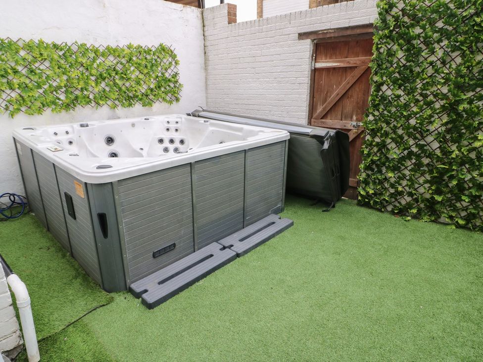 A hot tub with a cover in a garden at 16 Seafield Terrace South Shields